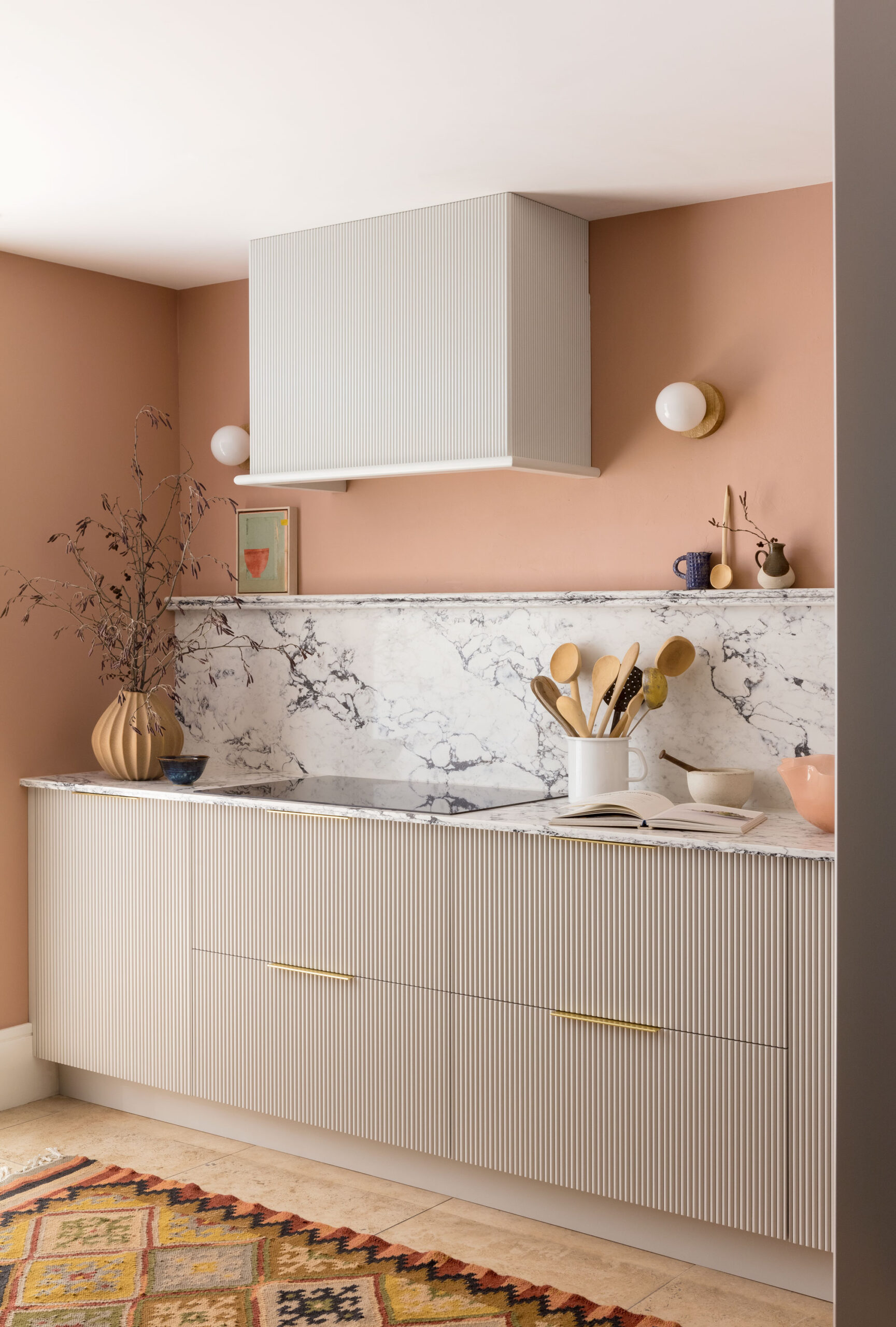 Harvey Jones and Swoon kitchen design featuring reeded cabinetry with marble worktop and splashback