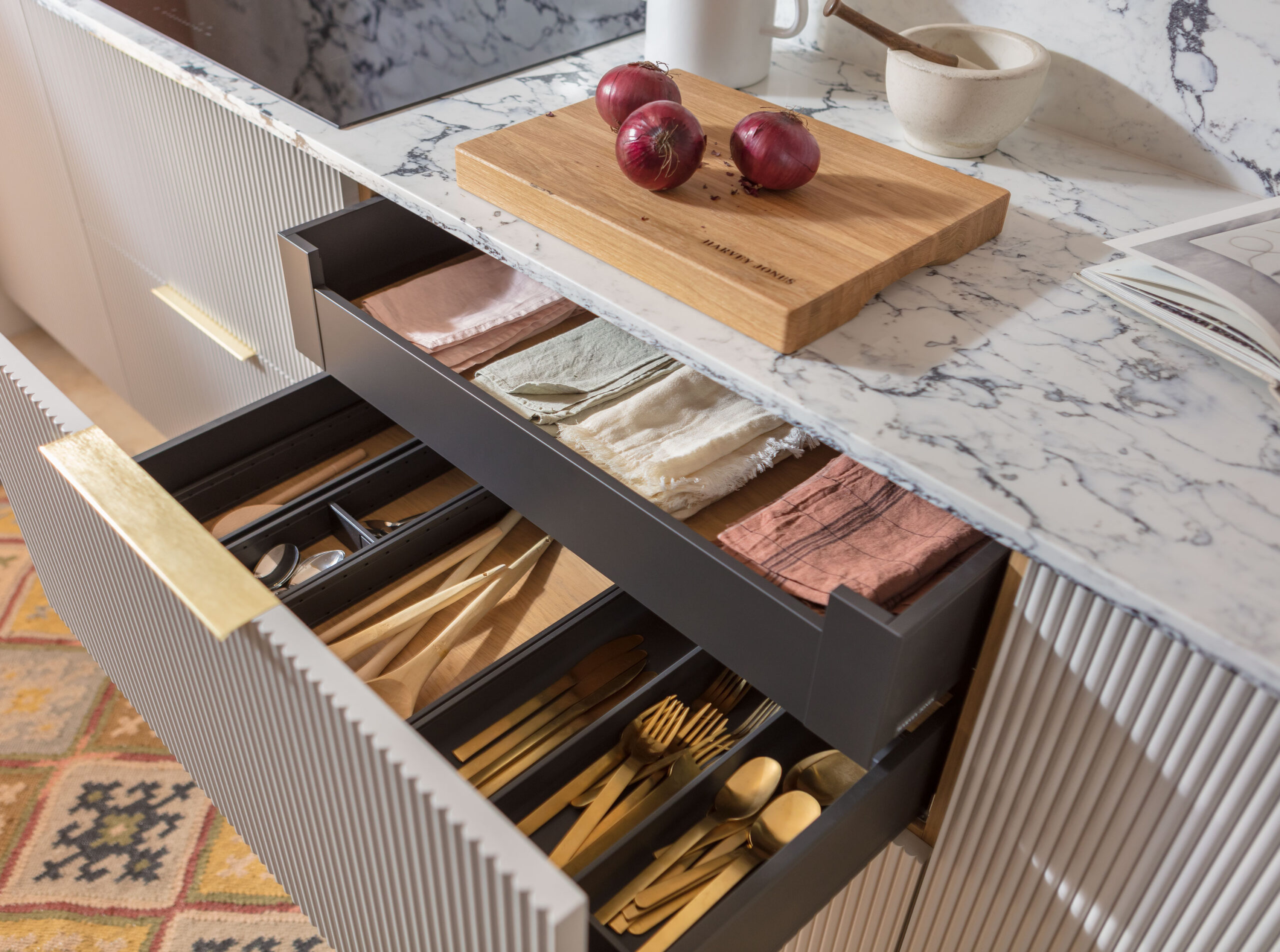 Closeup of Harvey Jones reeded kitchen drawer open to show organised storage