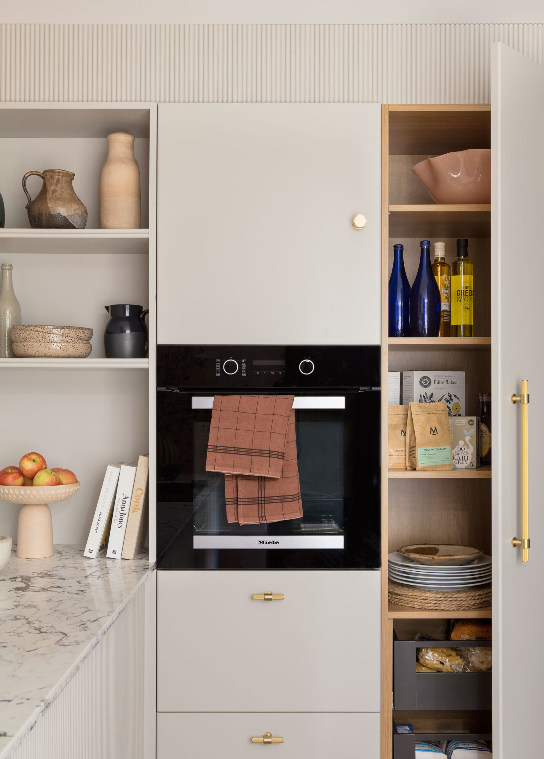 Kitchen appliance integrated within Harvey Jones X Swoon cabinetry with organised shelving