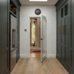 Green Shaker galley kitchen entrance