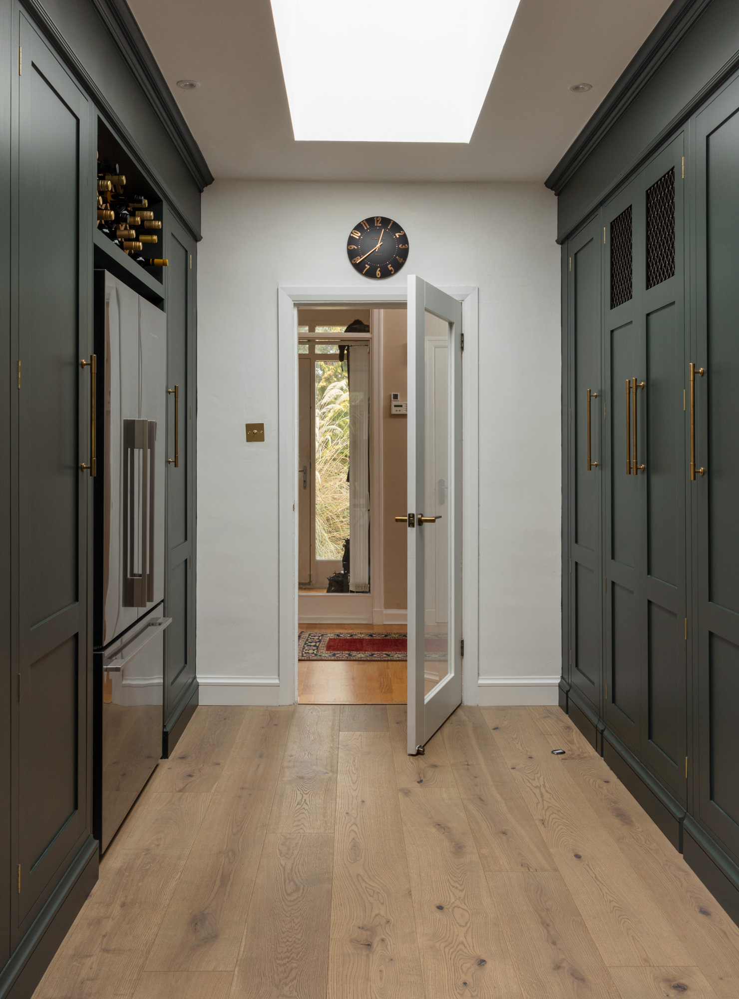 Green Shaker galley kitchen entrance