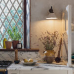 Closeup of cream Arbor kitchen cabinetry featuring brass handles