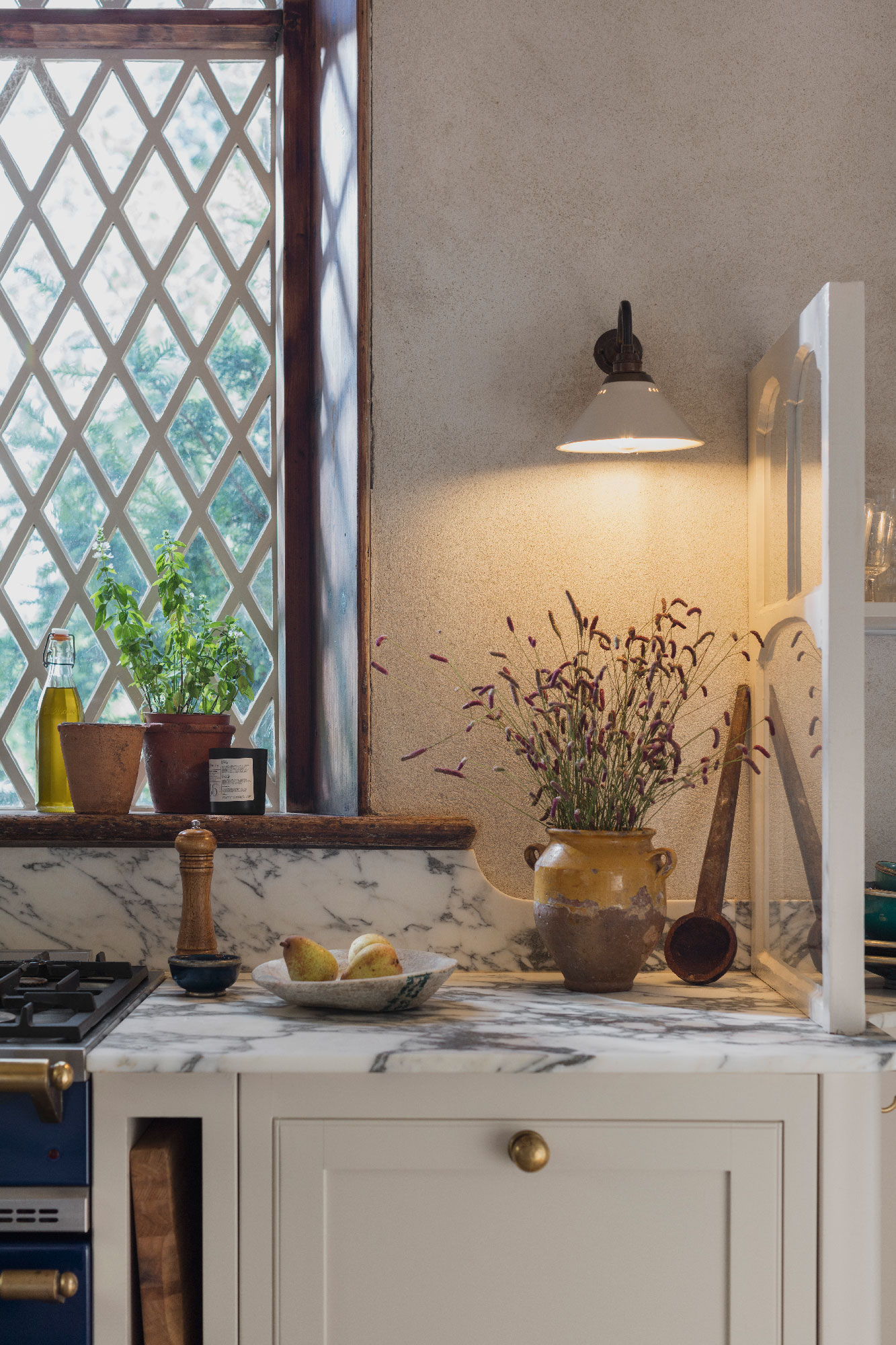 Closeup of cream Arbor kitchen cabinetry featuring brass handles