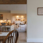 White Original kitchen design viewed from open dining area