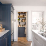 Blue Shaker kitchen cabinetry and walk-in pantry