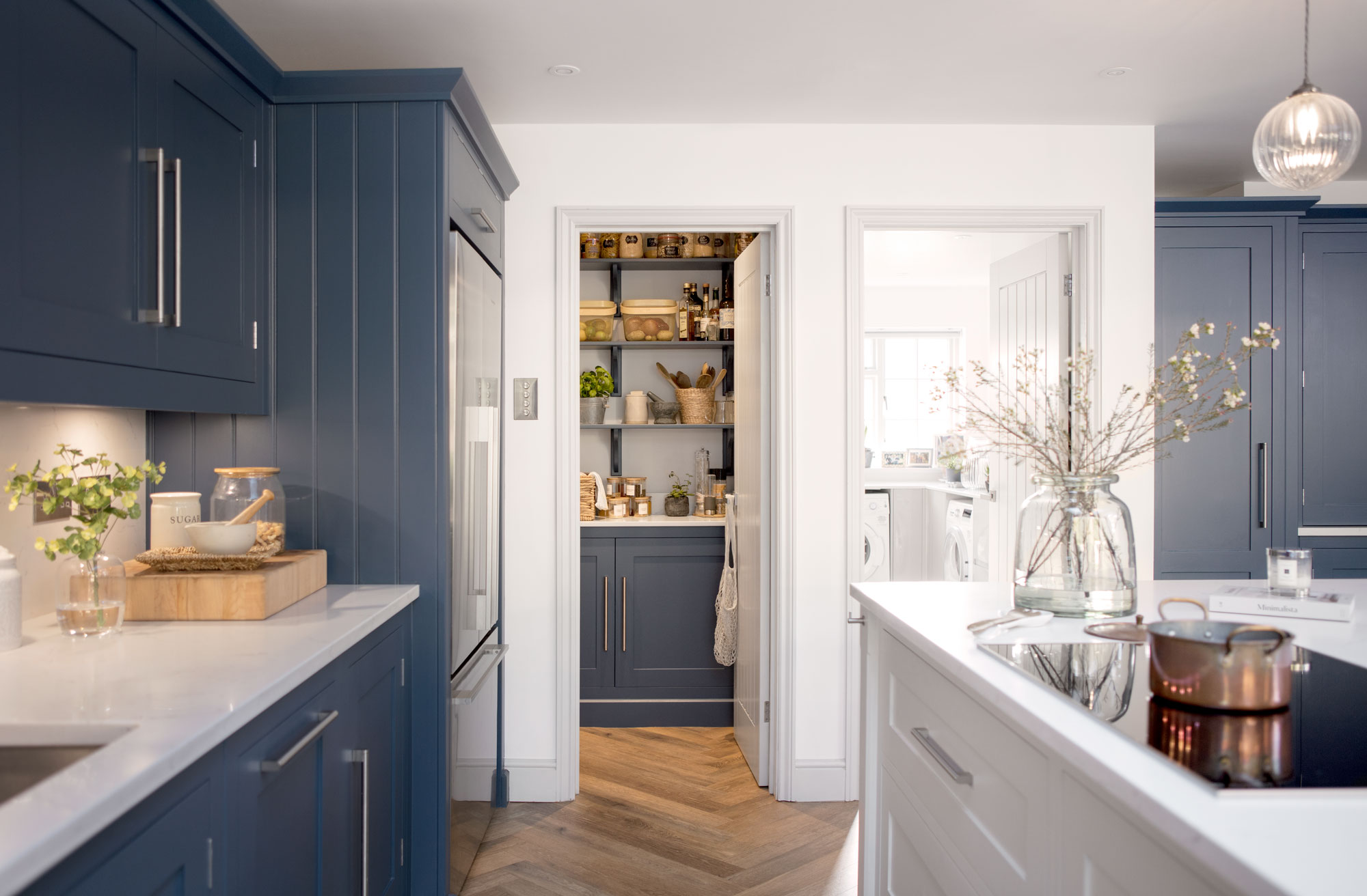 Blue Shaker kitchen cabinetry and walk-in pantry