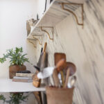 Closeup of marble kitchen splashback with marble shelving