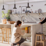Female using kitchen island storage shelves