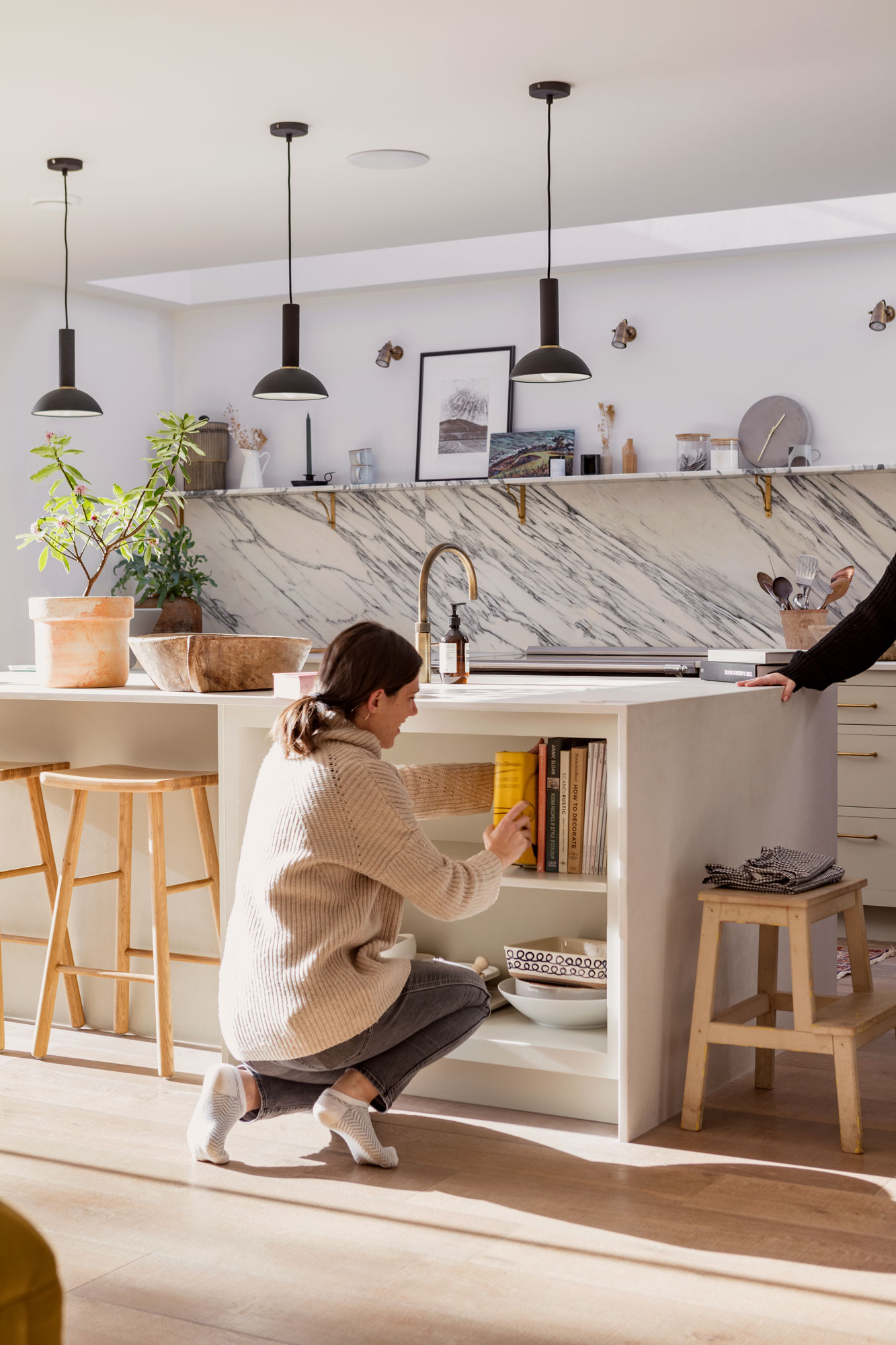 Female using kitchen island storage shelves