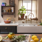 Teal Original kitchen cabinetry with white basin sink and brass tap