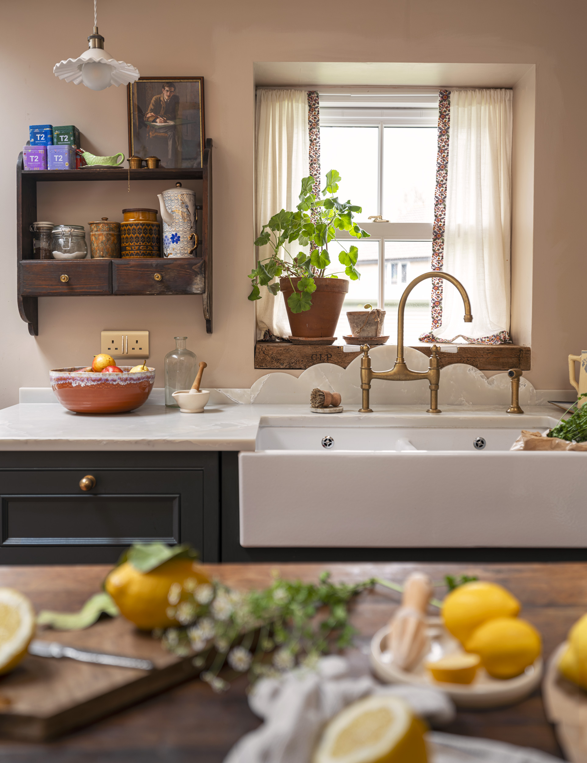 Teal Original kitchen cabinetry with white basin sink and brass tap