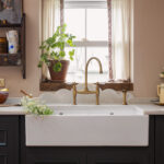 Teal Original kitchen cabinetry with white basin sink and brass tap