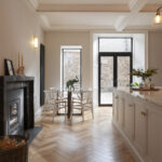 White Arbor kitchen island with white worktop next to a kitchen dining area