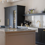 Beige Arbor kitchen island next to dark Arbor cabinetry