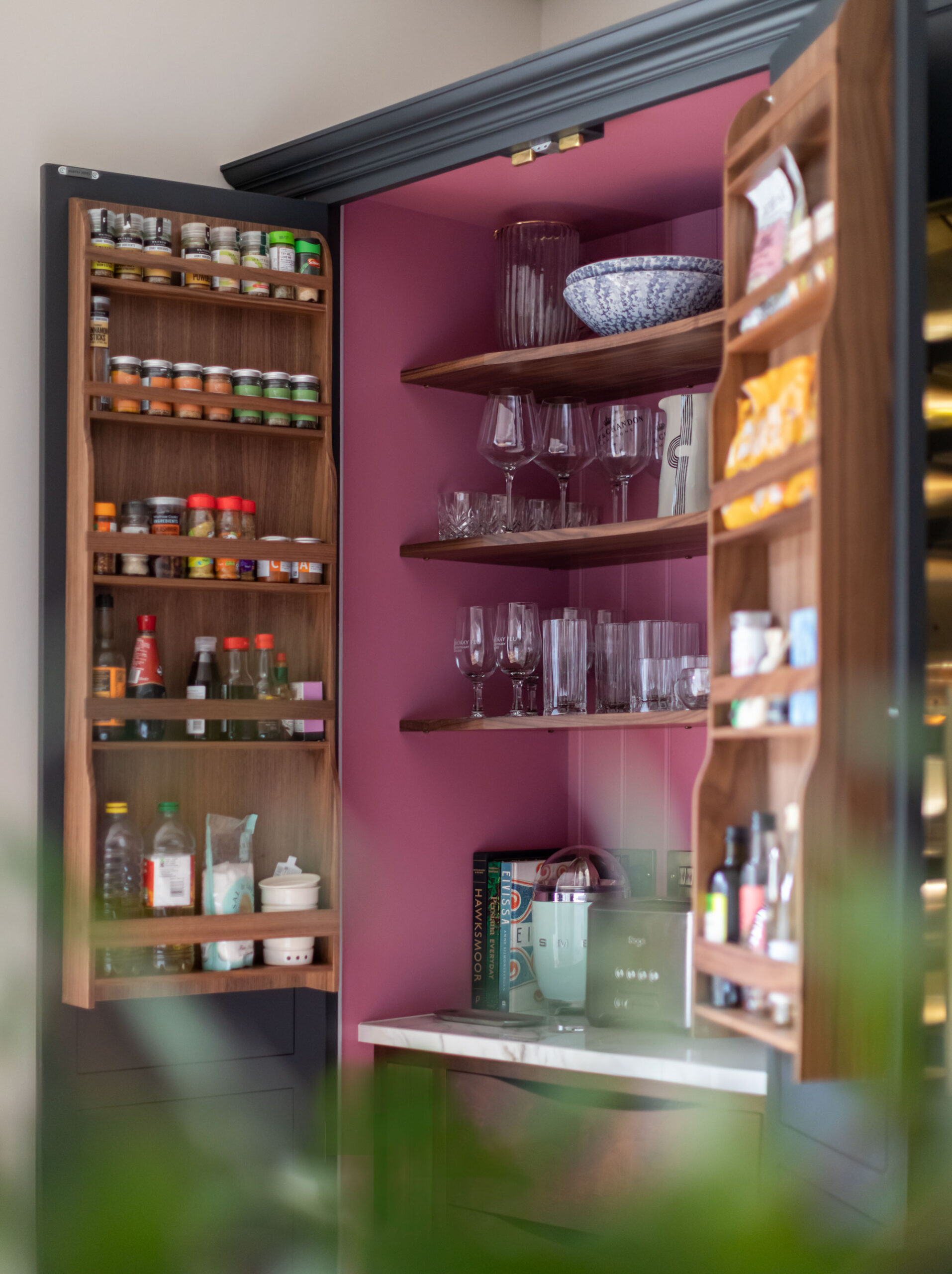 Open dark Arbor kitchen pantry with storage organisation and burgundy lining