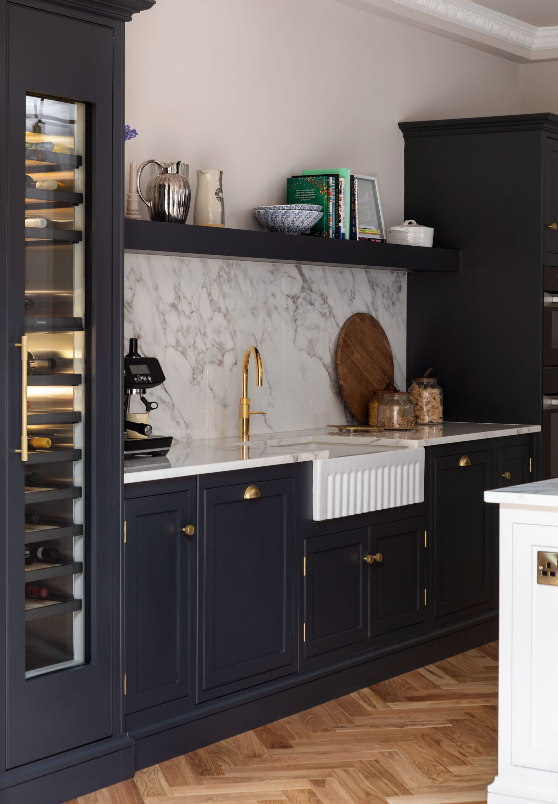 Dark Arbor kitchen cabinetry featuring white marble worktops and splashback