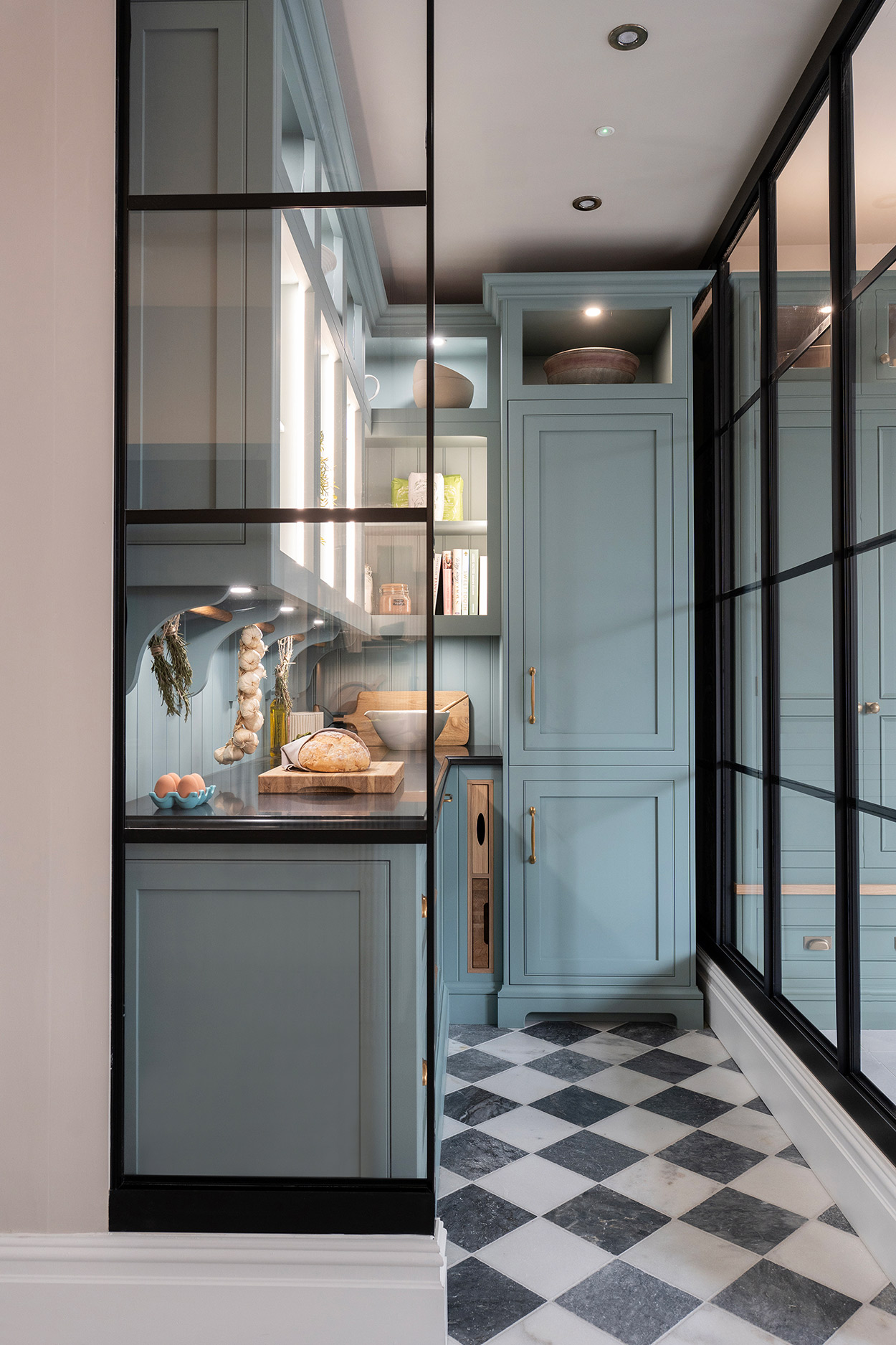 Bespoke walk in pantry with concealed fridge and open shelving with Crittal doors