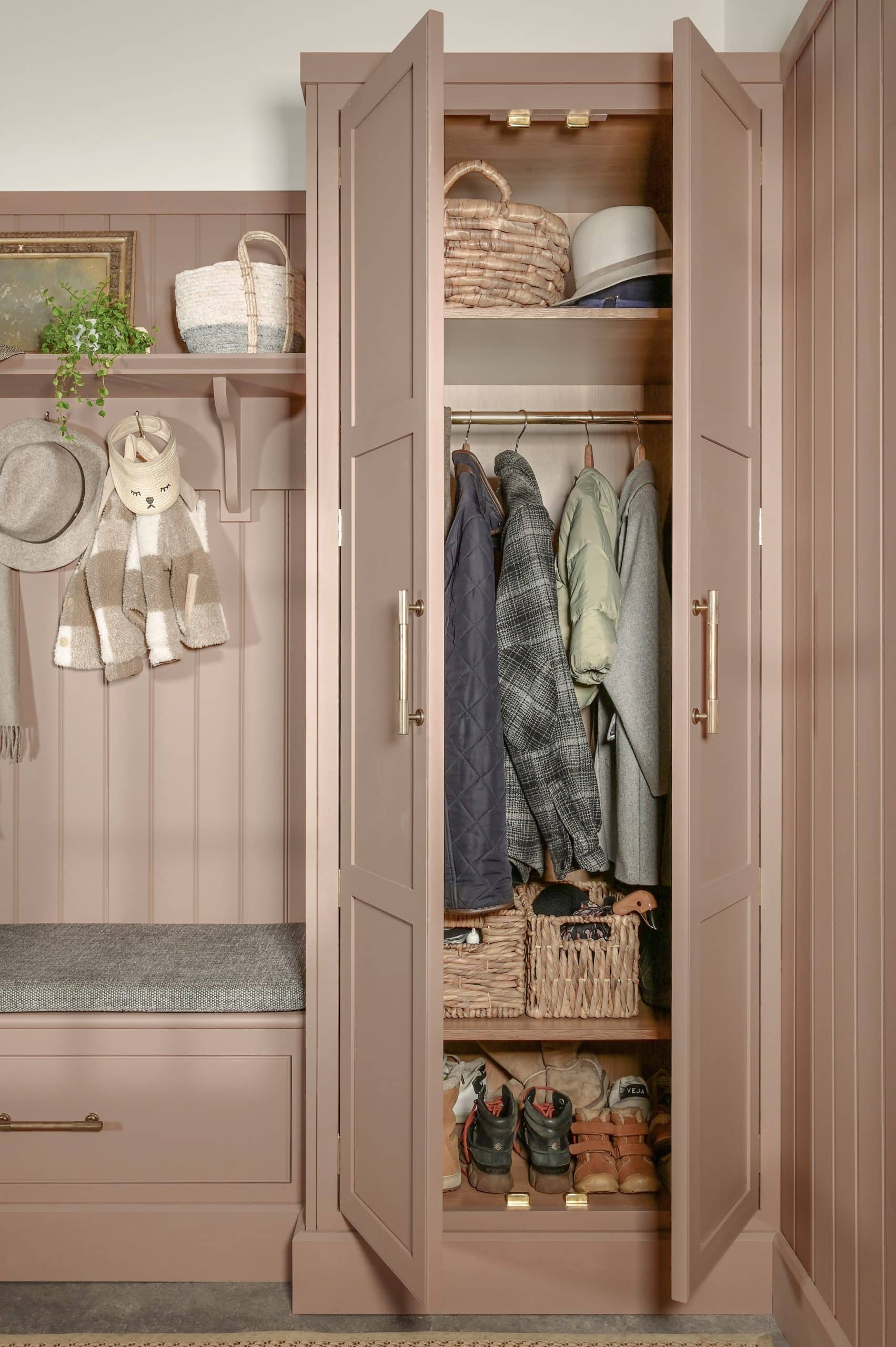Pink boot room open to show organised storage
