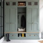 green luxury boot room with bench seating and glazed cabinets