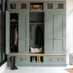 green luxury boot room with hanging storage and bench seating