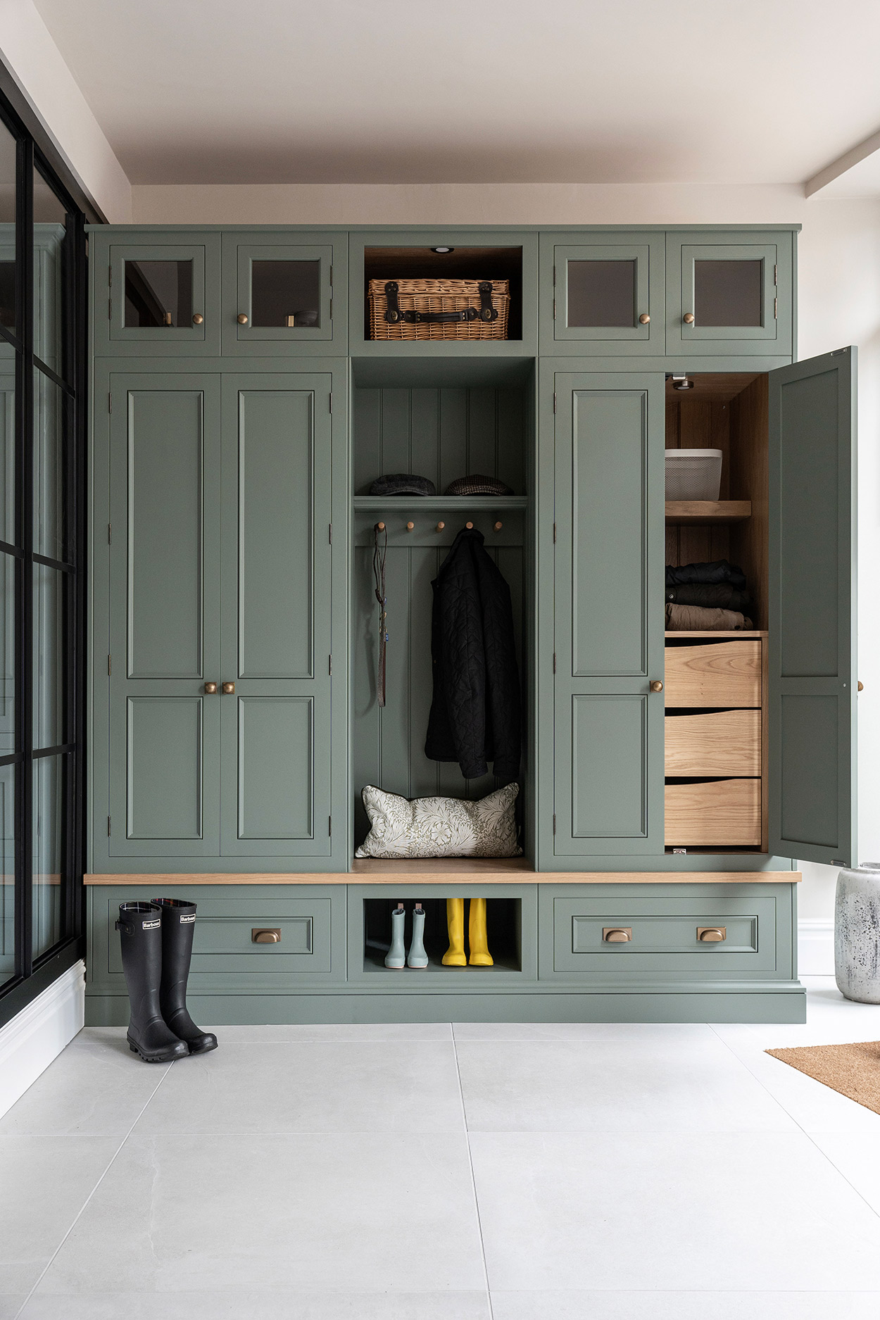 green luxury boot room with concealed drawer storage