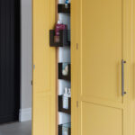 Innovative utility room storage with pullout shelving with glass fronts.