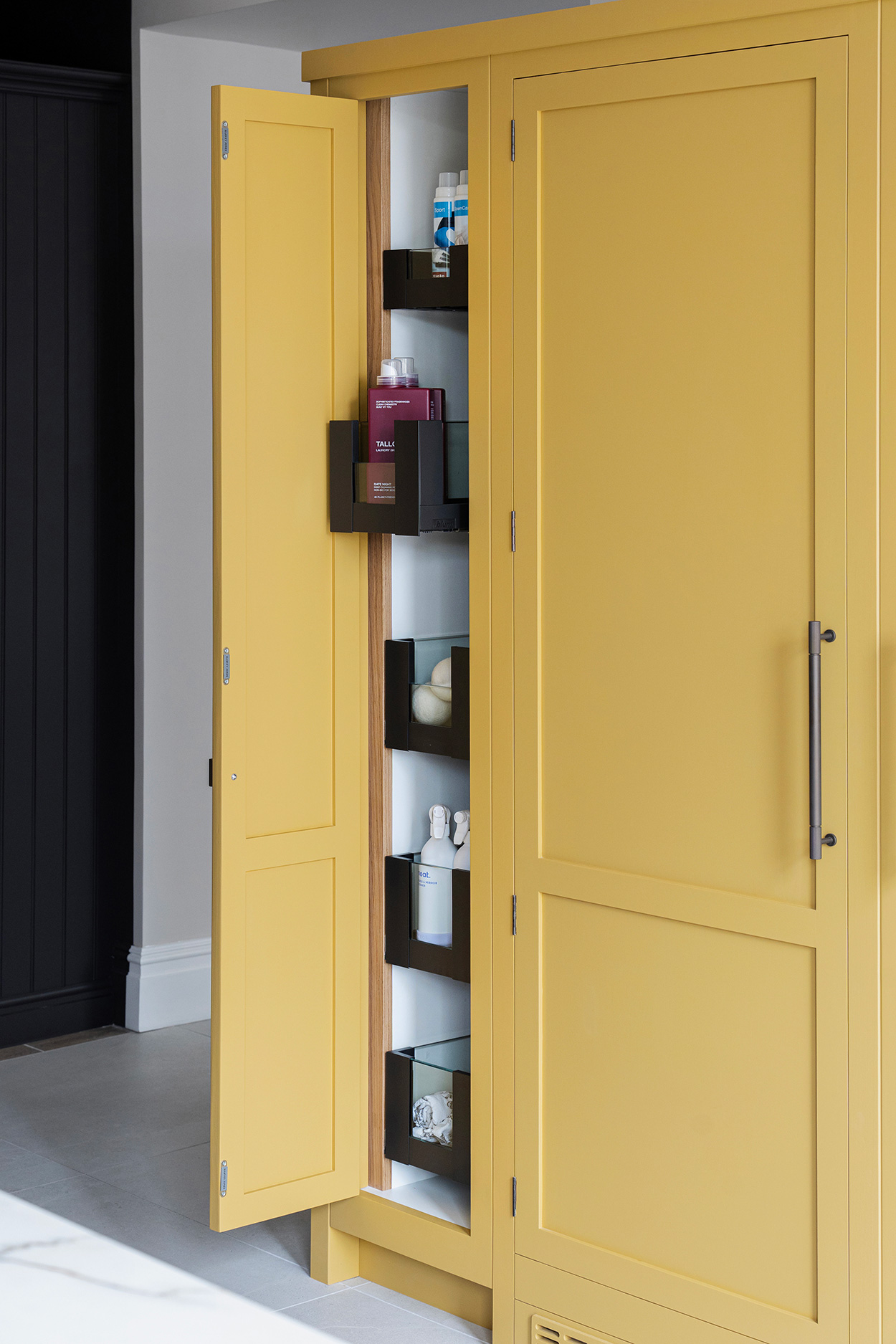 Innovative utility room storage with pullout shelving with glass fronts.