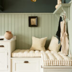 White corner bench seating featuring pale green wood cladding