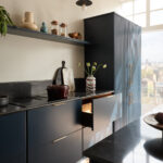 Dark Harvey Jones X Swoon kitchen cabinetry featuring a black marble worktop