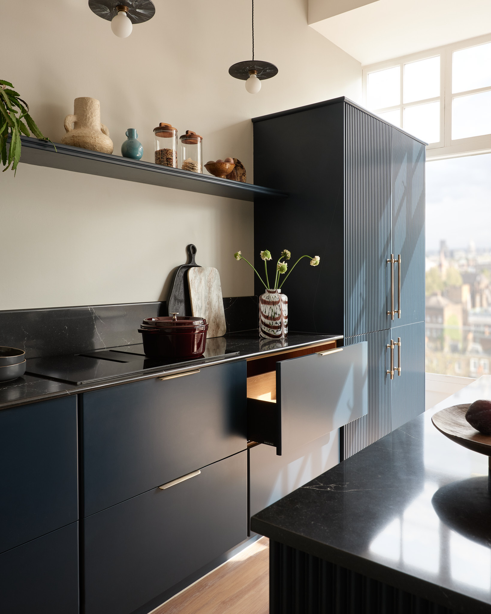 Dark Harvey Jones X Swoon kitchen cabinetry featuring a black marble worktop