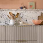 Harvey Jones and Swoon kitchen design featuring reeded cabinetry with marble worktop and splashback