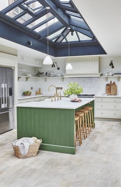 White kitchen cabinetry and green kitchen island