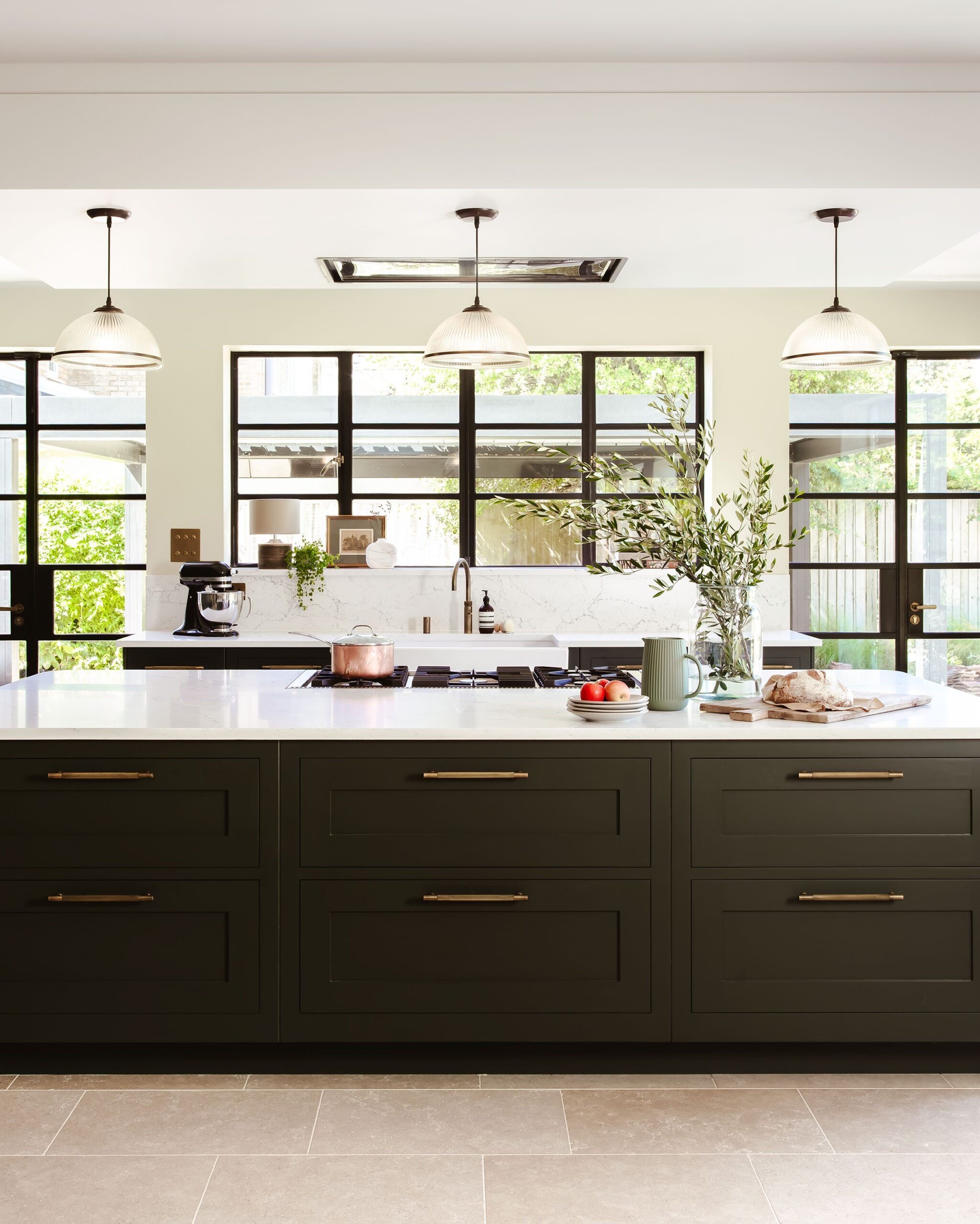 Dark green kitchen island with white worktop