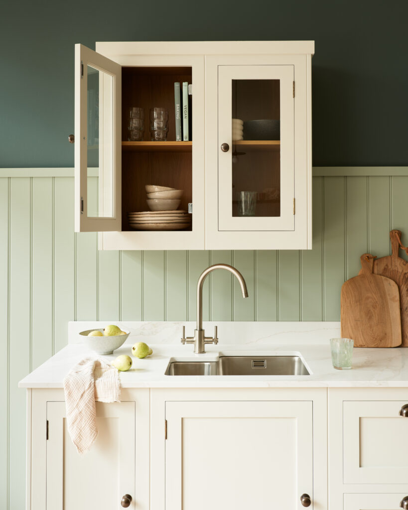 Beige overhead kitchen cupboard featuring glassware storage