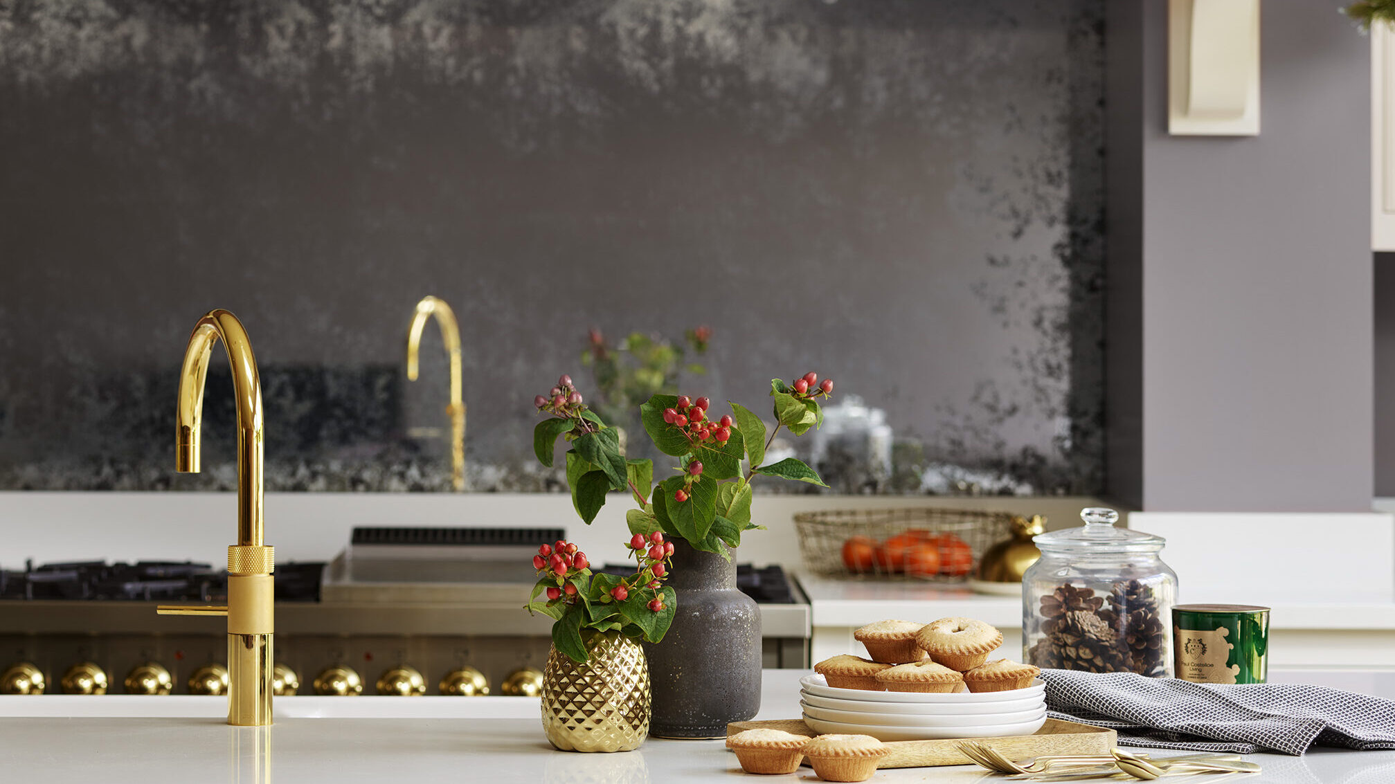 Dark kitchen design with white worktop featuring festive decorative elements