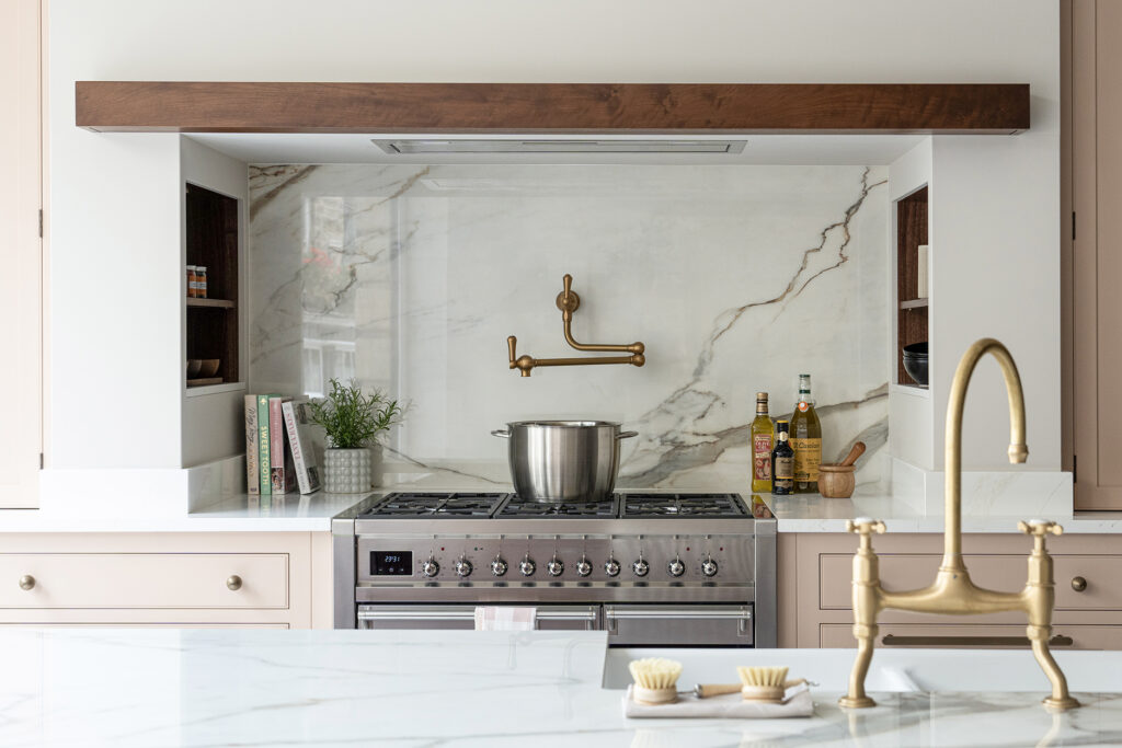 Kitchen cooking area with bespoke storage solutions including built in wall storage for spices and hidden extractor fan