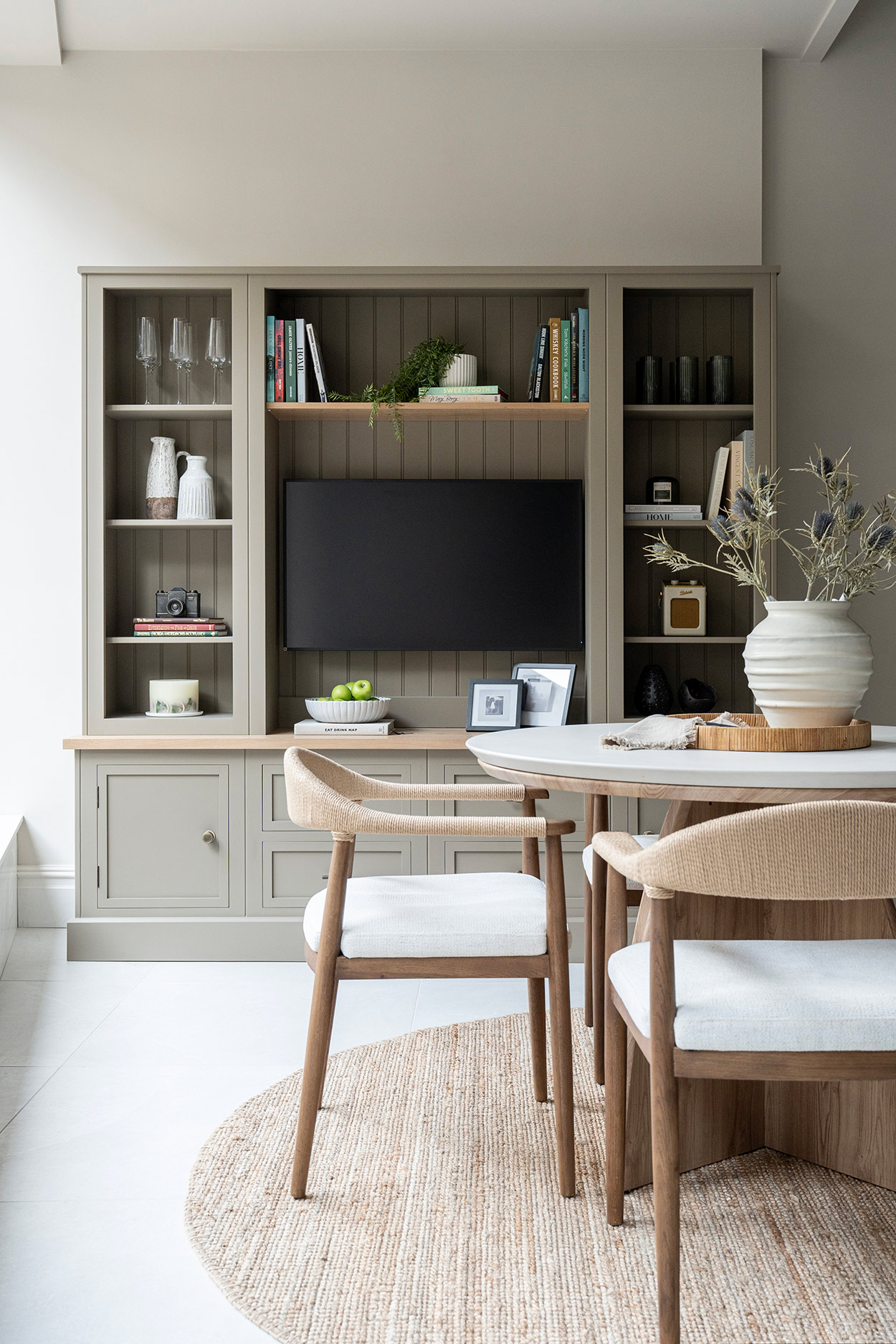 bespoke luxury media unit with marble table and chair in the foreground