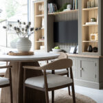 bespoke media furniture hand-painted in green with chair in foreground