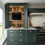 Green Shaker kitchen double dresser open to show hidden workspace and organised storage