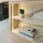Shaker kitchen island end panel shelving with stone surface shelves