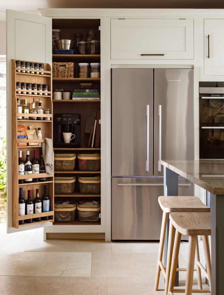 Organised slim pantry cupboard with bespoke storage in a luxury kitchen