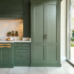 Green Kitchen with tall closed pantry doors