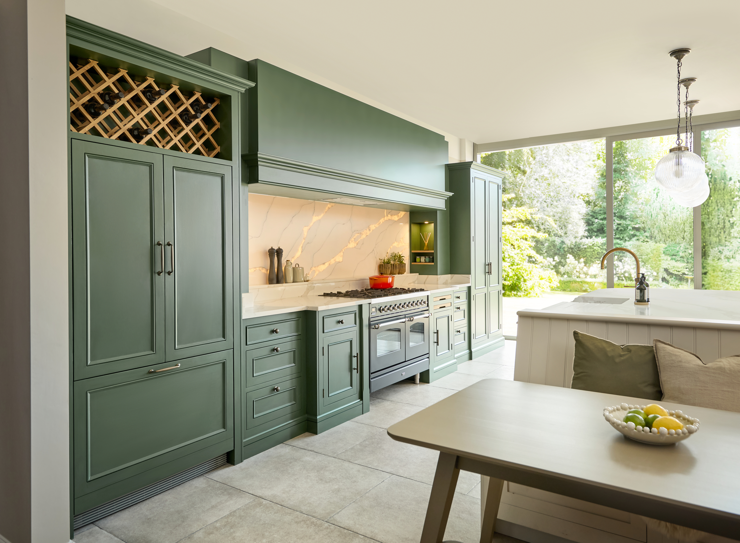 Green Kitchen with beige floor tiles and family dining table in the foreground