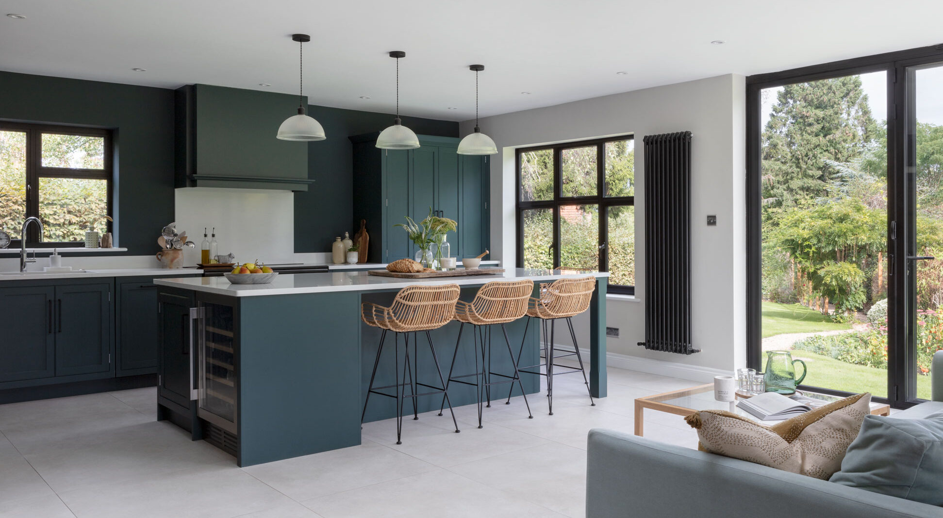 Colour drenched dark green kitchen with garden views