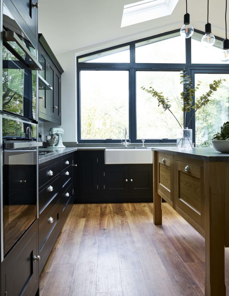 Black shaker kitchen with freestanding oak island unit