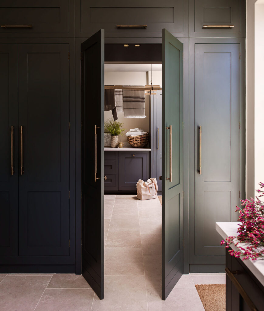 Secret utility room behind bespoke kitchen cabinet door