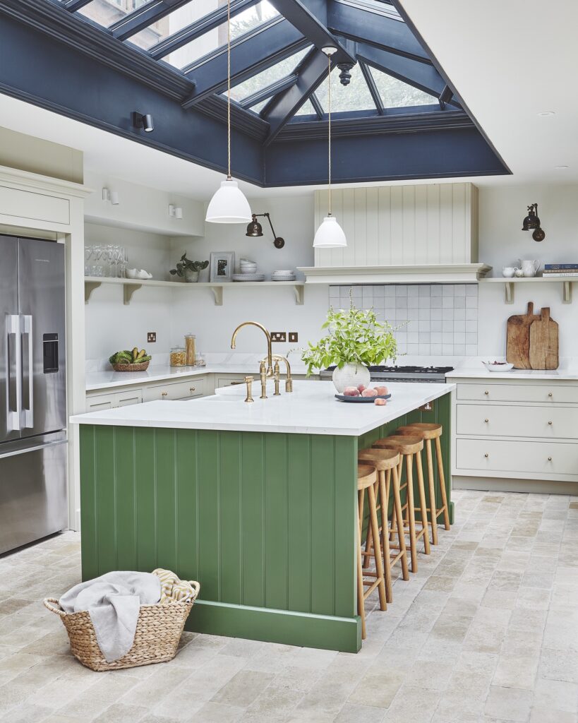 Arbor kitchen with a central green island and neutral cabinetry