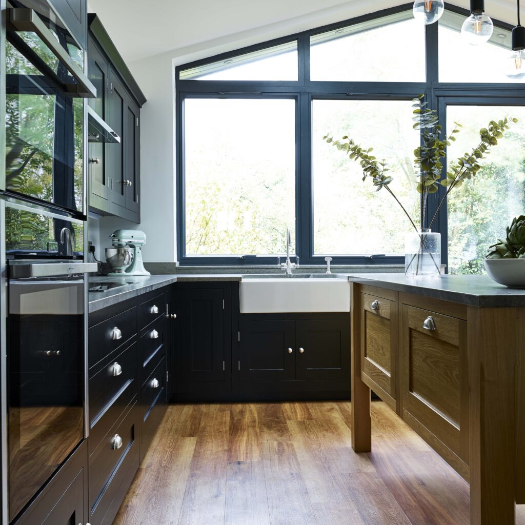 Black shaker kitchen with a mobile oak island