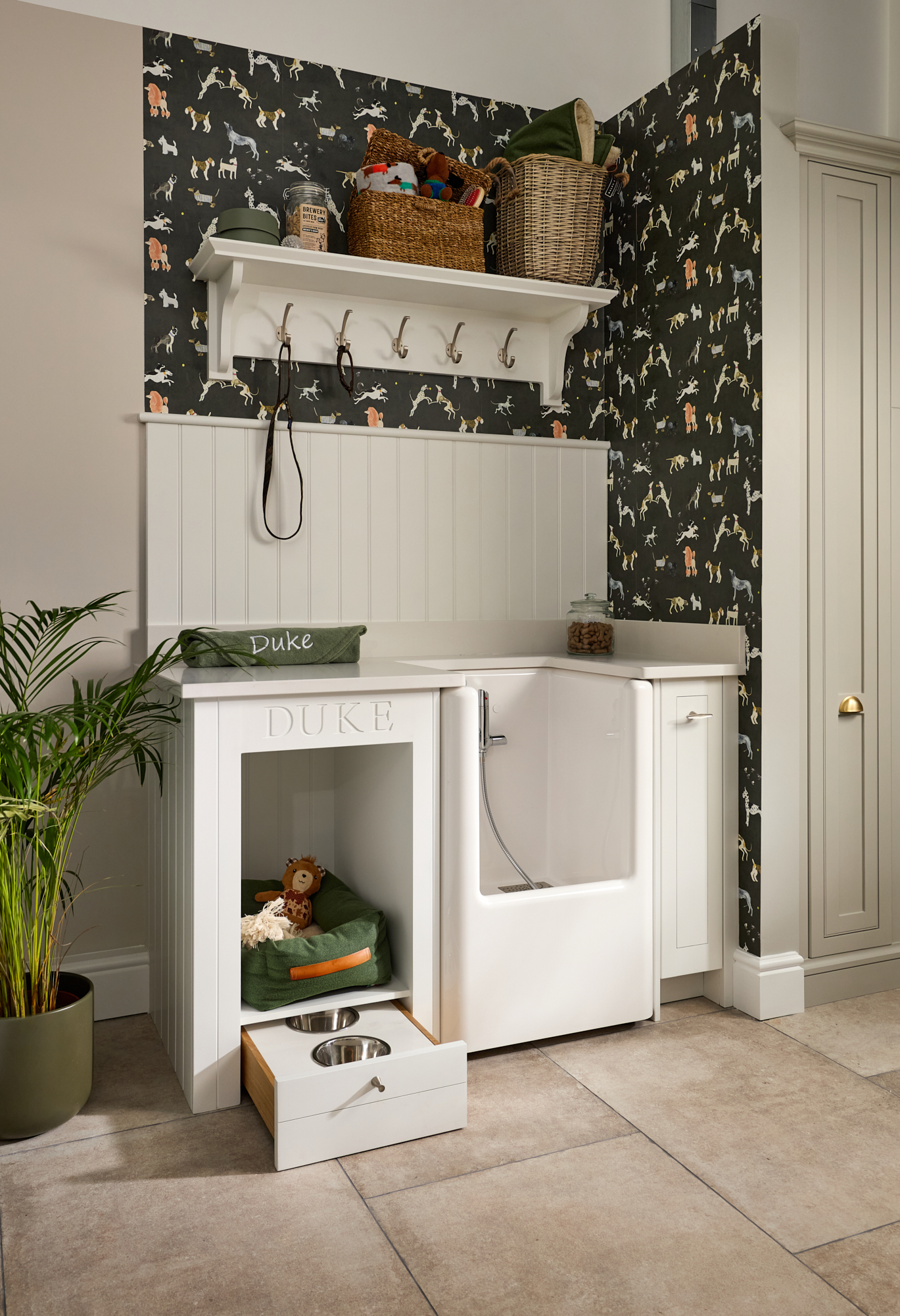 Built-in dog bed and feeding drawer in luxury utility room