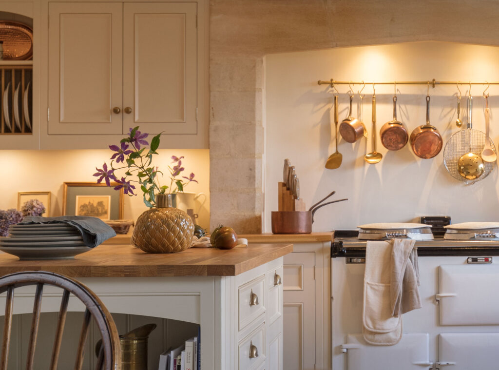 A kitchen featuring a stove and a dining table, showcasing a functional cooking and eating space.